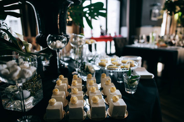 Beautiful black decoration wedding dessert table in restaurant