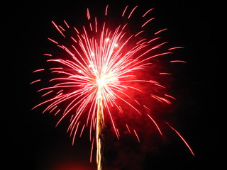Red firework on black background