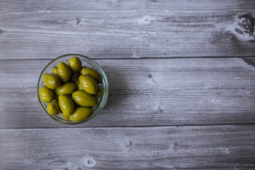 fresh green olives n a dark wooden background