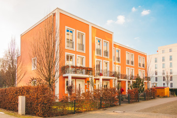 beautiful townhouses in a row with orange facade on a sunny day