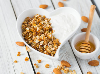 breakfast with granola on wooden surface