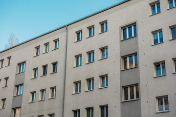 white and grey apartment building in plattenbau style