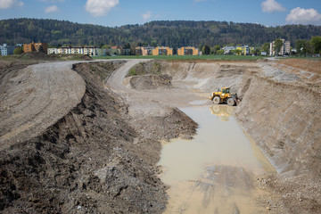 Yellow excavator on a construction site