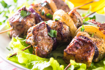 Grilled shish kebab or shashlik on white.