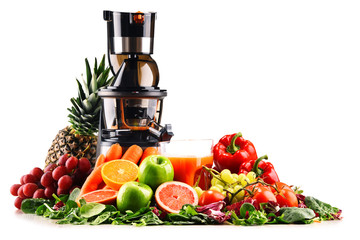 Slow juicer with organic fruits and vegetables isolated on white