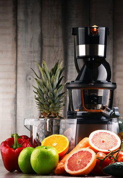 Slow juicer with organic fruits and vegetables.