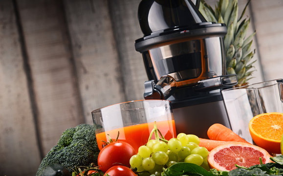 Slow juicer with organic fruits and vegetables.