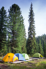 Family Enjoying Camping Holiday In Countryside