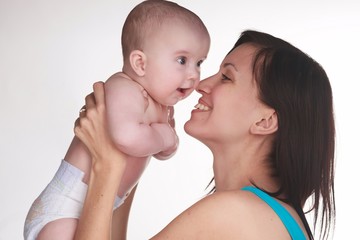 Mother and little boy playing together in studio