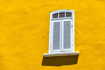 Vintage window on the yellow wall background