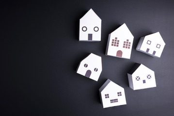 White paper house toy on black background with copy space.Real estate concept, New house concept, Finance loan business concept.