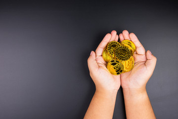 Cryptocurrency golden bitcoins coin in girl hand. Electronic virtual money for web banking and international network payment. Symbol of crypto currency.
