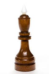 Fototapeta na wymiar The macro shot of the black chess king of wood on the white background. The chess piece is isolated on white and a clipping path is provided for easy extraction.