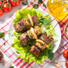 Grilled shish kebab or shashlik on white.