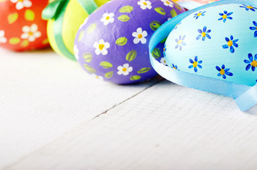 Painted decorated easter eggs on white table
