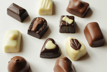 Pralines made of black, white and milk chocolate