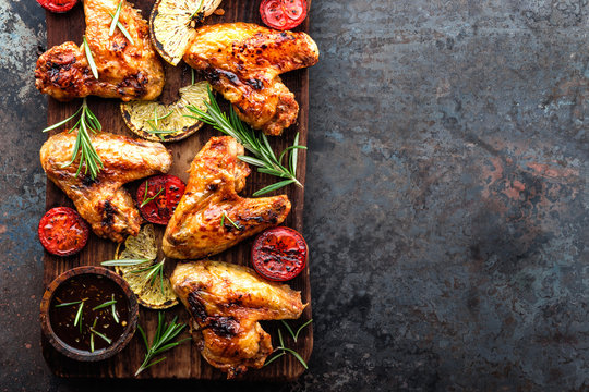 appetizing chicken wings grilled barbecue with spices and vegetables until crispappetizing chicken wings grilled barbecue with spices and vegetables until crisp, top view, space for text