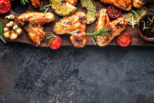 appetizing chicken wings grilled barbecue with spices and vegetables until crispappetizing chicken wings grilled barbecue with spices and vegetables until crisp, top view, space for text