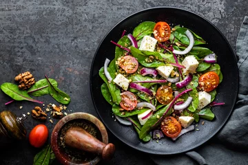 Fotobehang bord voedzame eenvoudige salade met snijbiet, walnoten, zachte kaas, uien en olie, bovenaanzicht, ruimte voor tekst © Sunny Forest
