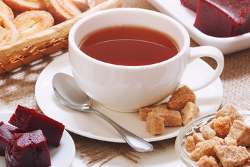 Brown traditional tea with cane sugar and cherry jam