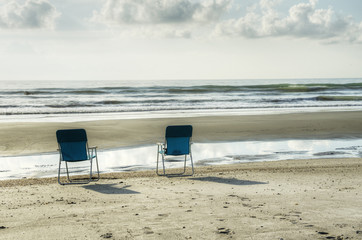 Empty Chairs at Sunrise in Cocoa Beach, Florida.