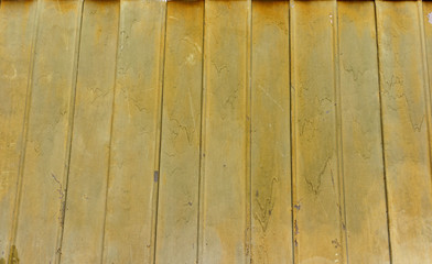 Vintage wooden fence with traces of old paint, scuffs and scratches. Photo close-up 