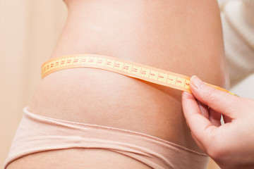 taking measures of woman's waist