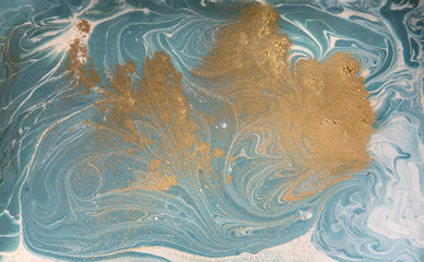 Marble abstract acrylic background. Nature blue marbling artwork texture. Golden glitter.