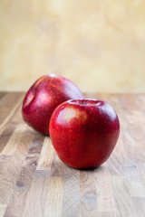 Fototapeta na wymiar two ripe juicy apples lying on an oak table