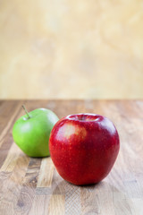 two ripe juicy apples lying on an oak table