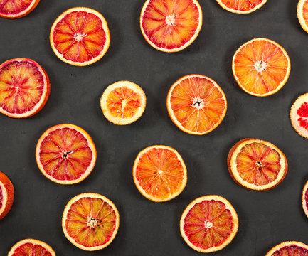 Red oranges on black background.