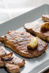 Roast pork shrubs meat with garlic on the plate