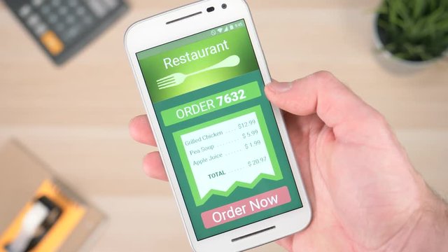 Ordering food online from a restaurant with a smartphone device.