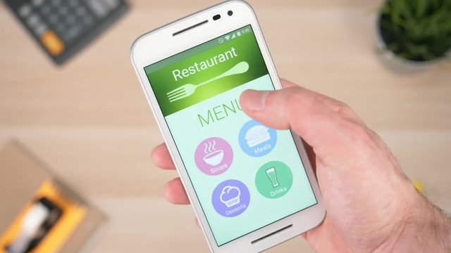 Looking at the menu of a restaurant online on a smartphone device. Scrolling trough the soups and looking at prices.