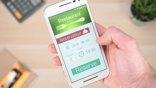 Making a restaurant reservation online on a smartphone.