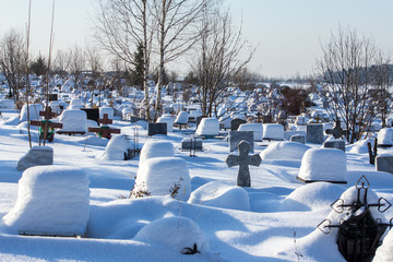 snow-covered cemetery on a frosty winter day