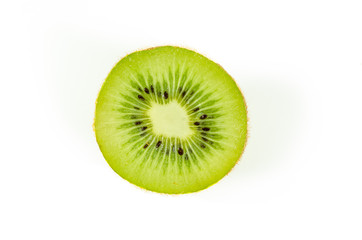 Fototapeta na wymiar Fresh green kiwi fruit slice close up partially isolated on white background with selective focus, view from above