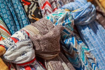 Scarves and cheiches hung in a store to be sold