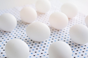 White eggs on polka dot fabric