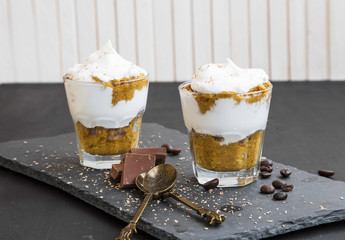 Tiramisu italian dessert in glasses with mascarpone cream and chocolate