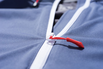 Zip of a blue sports jacket to use as a background