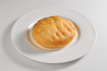 Round dish with salted round focaccia