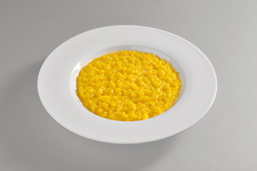 Round dish with yellow Milanese risotto