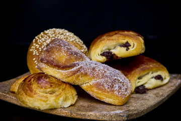 Assorted Mexican sweet breads served on a onyx plate, showcasing traditional pastries in a refined breakfast composition.