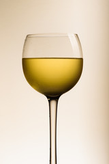 Glass of white wine on white background