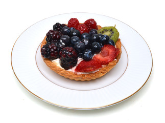 Fresh fruit tart in white plate on white