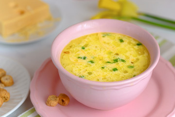 Cheese soup with croutons and fresh herbs.