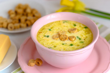 Cheese soup with croutons and fresh herbs.