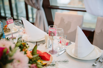 the table of the bride and groom at the wedding Banquet. Decorated glass bride