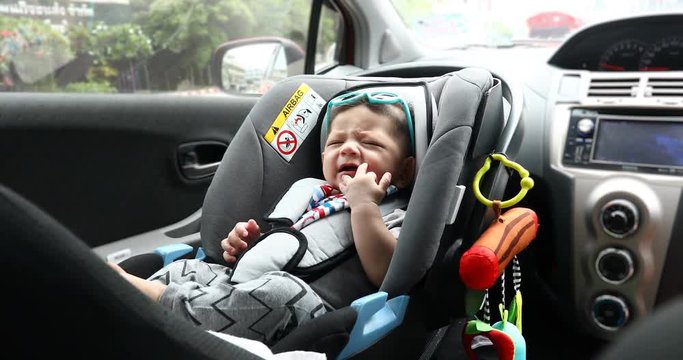 baby sitting in car seat safety driving of family travel road trips